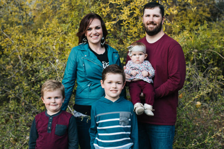 Family of 5 smiling outdoors