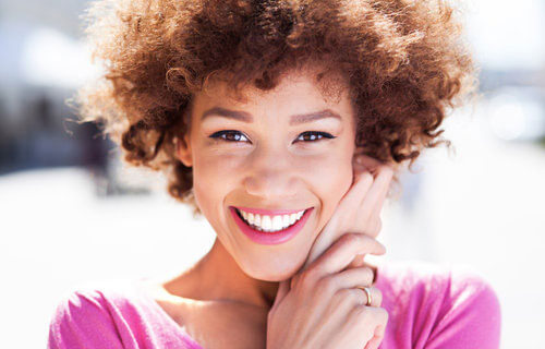 Young woman smiling outdoors