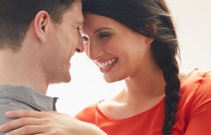 Young couple smiling and leaning towards each other