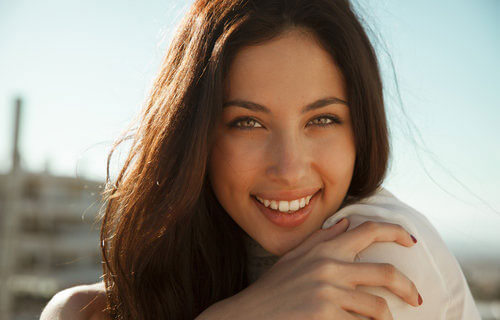 Young woman smiling outdoors