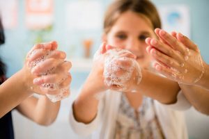 Young girl washing her hands