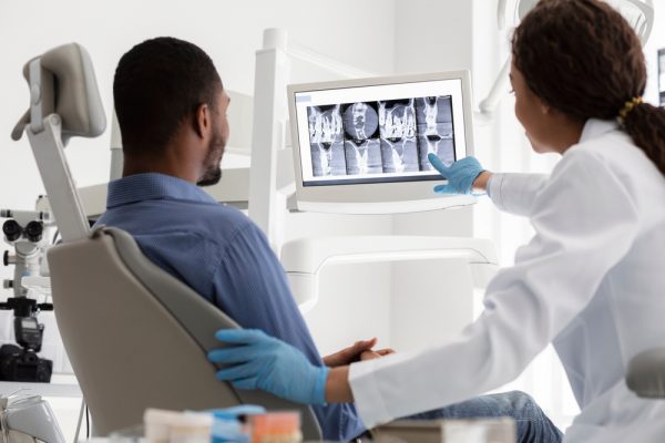 dentist showing patient x-rays
