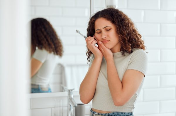 young woman has tooth pain