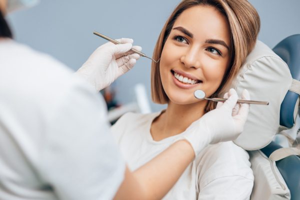 young woman with short hair getting dental exam